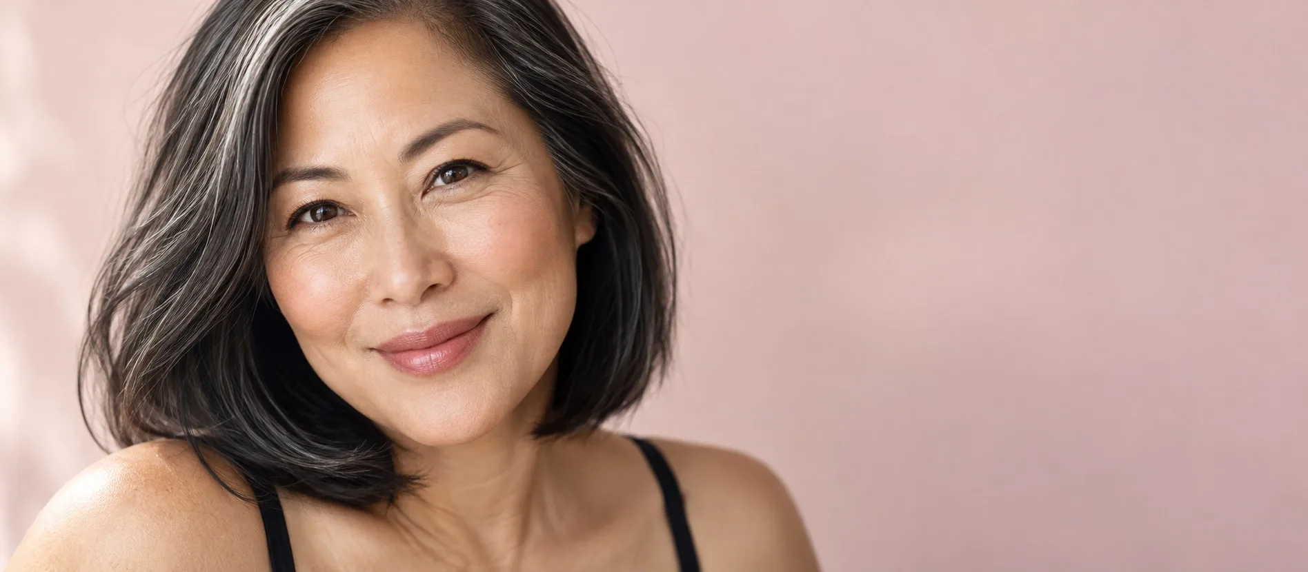 Close-up portrait of a smiling woman in her fifties